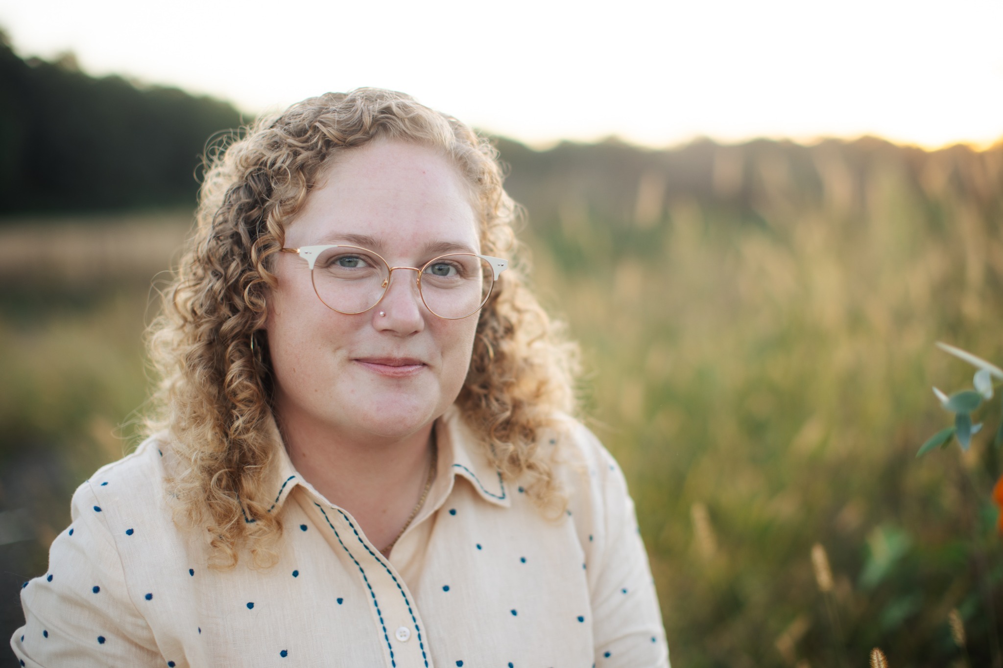 Emma Rose Hardy outdoors in warm evening light.